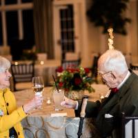 Two guests toasting.